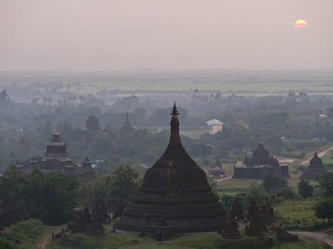 Hazy sunset over Mrauk U in the northern part of the Rakhin State, Myanmar. Mrauk U was the capital of the Mrauk U Kingdom from 1430 to 1785.