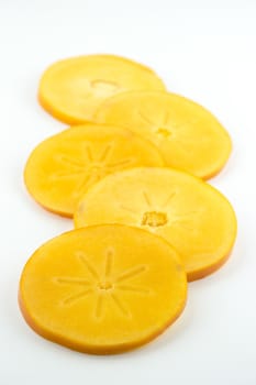 group of orange persimmon slices isolated on white background