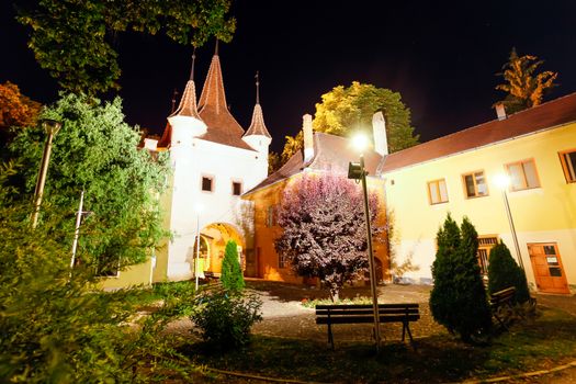 Brasov, Romania - July 24, 2013: Ecaterina Gate tower backyard illuminated at night, Brasov, Romania