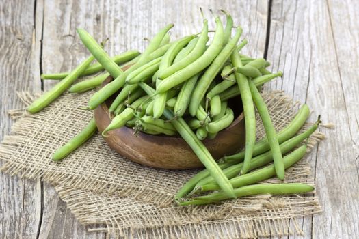 green beans on wooden background