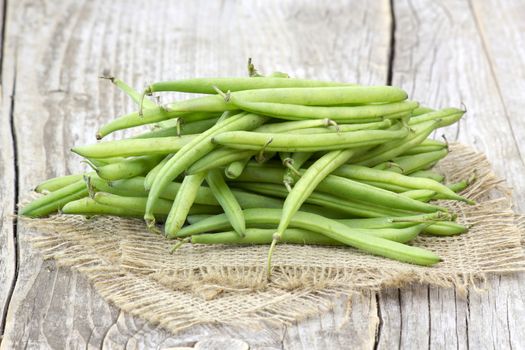 green beans on wooden background