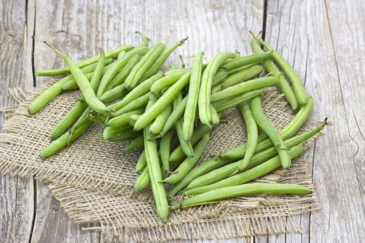 green beans on wooden background