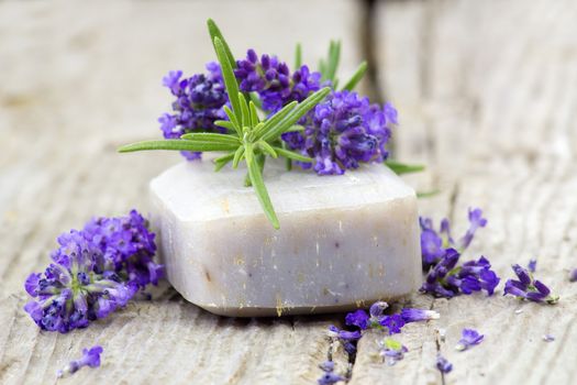bar of natural soap and lavender flowers