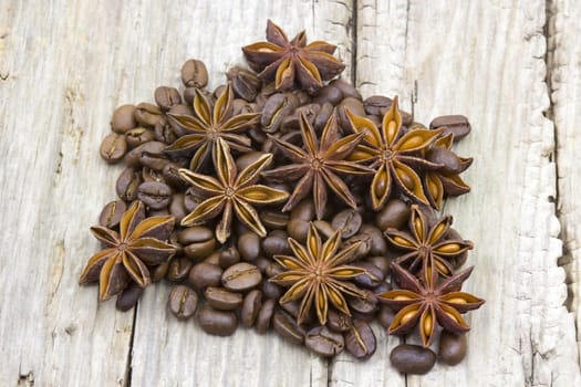 anise and coffee beans on wooden background