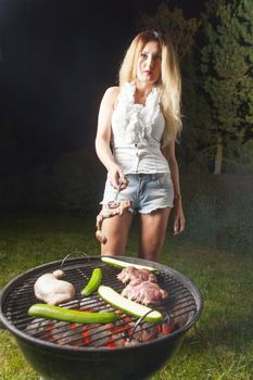 woman cooking on the barbecue