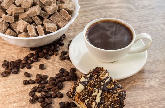 cup of black coffee on a wooden background with cookies and brown sugar
