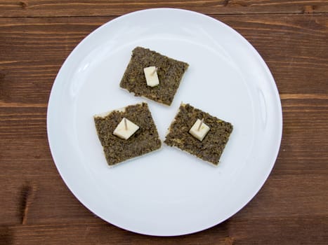 Canapes with olive paste on wooden table top views