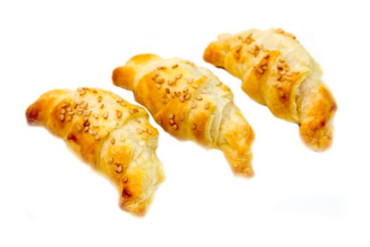 Savory croissants with sesame on white background