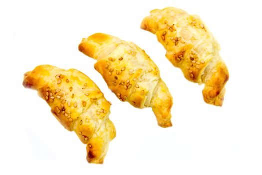 Savory croissants with sesame on white background seen from above