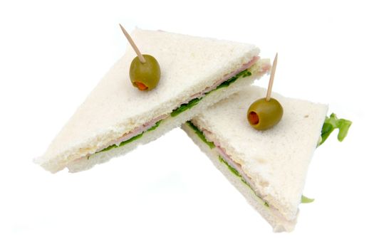 Triangular sandwiches on white background seen up close