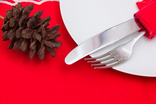 Cutlery on plate with Christmas decorations seen up close