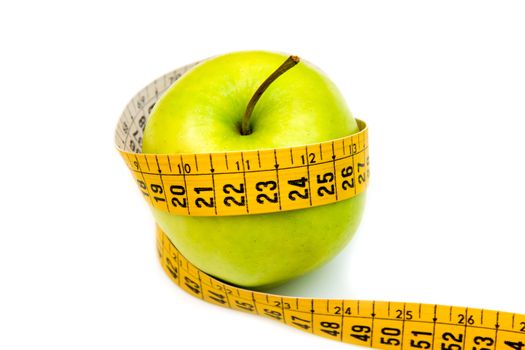 Apple with tape measure on white background