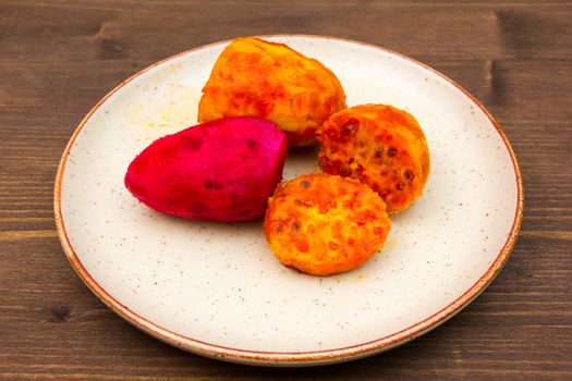 Prickly pear cut on plate on wooden table