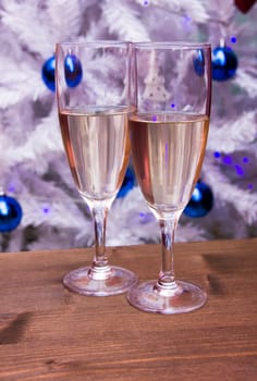 Flute with sparkling wine in front of Christmas tree