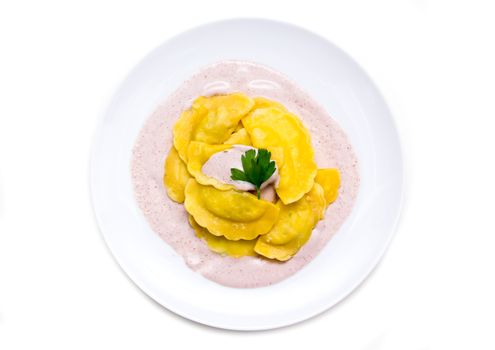 Ravioli with radicchio sauce on a white background seen from above