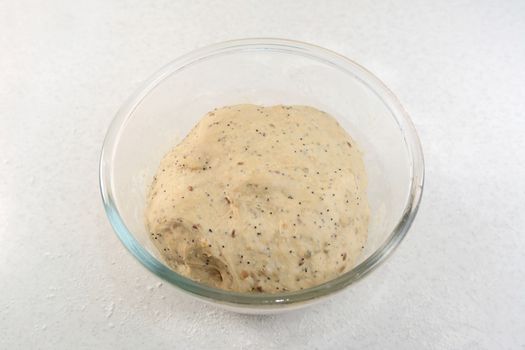 Proved bread dough, having risen and doubled in size in a glass bowl