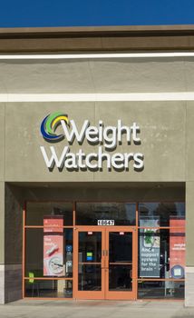 GRANADA HILLS, CA/USA - DECEMBER 26, 2014: Weight Watchers International exterior and sign. Weight Watchers offers various products and services to assist weight loss and maintenance.