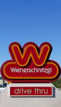 SANTA CLARITA, CA/USA - DECEMBER 25, 2014: Wienerschnitzel fast foot restaurant sign.  Wienerschnitzel is an American fast food chain that specializes in hot dogs.