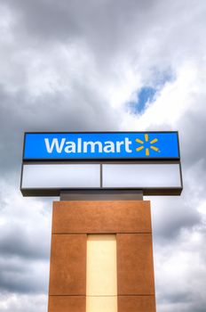 ROSEVILLE, MN/USA - JUNE 28, 2014: Walmart store sign. Walmart is an American multinational corporation that runs large discount stores and is the world's largest public corporation.