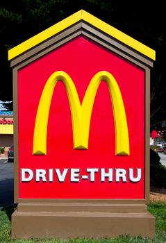 SAND CITY, CA/USA - JULY 15, 2014: McDonald's Drive-Thru sign. The McDonald's Corporation is the world's largest chain of hamburger fast food restaurants.