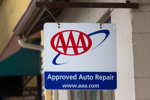 MONTEREY, CA/USA - MAY 23, 2014: AAA Sign in front of auto repair garage. The  AAA is a non-profit federation of motor clubs in North America.