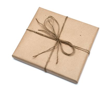 parcel wrapped with brown kraft paper isolated on white background