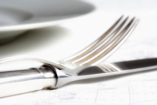 elegant table setting with silverware on white cloth