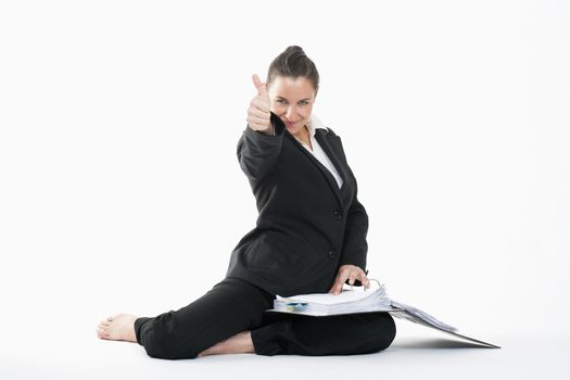 happy young businesswoman with files showing thumbs up
