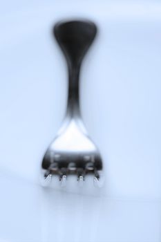 elegant table setting with silverware and plate-closeup of a fork