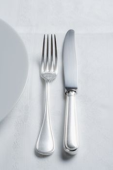 elegant table setting with silverware and white plate