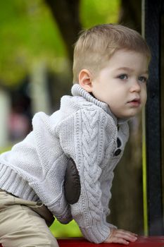 2 years old Baby boy on playground in spring outdoor park 