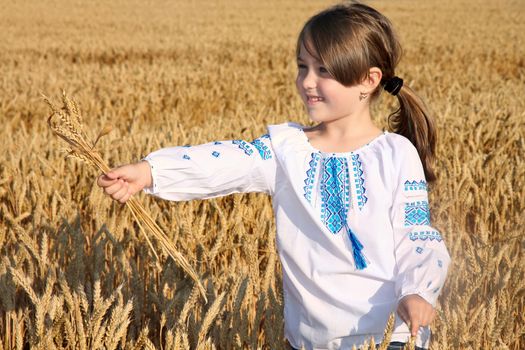 small rural girl on wheat field