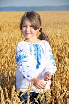 small rural girl on wheat field