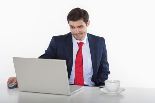 young business executive in suit behind desk with laptop
