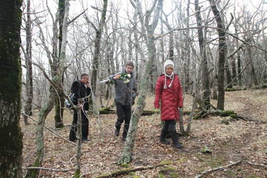 Krasnodar region, Russia - March 23, 2012. Inspection ecologists near the Governor's house Tkachev. Evgenia Chirikova, Igor Bakirov and the unknown journalist in the box wood near a cottage of the governor Tkachyov
