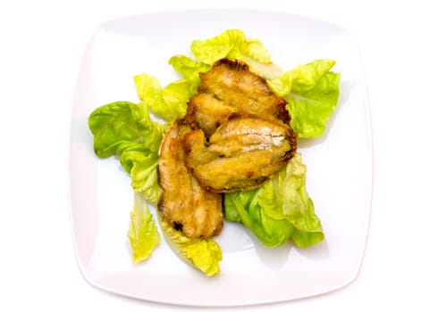 Fried fish on salad on white background seen from above