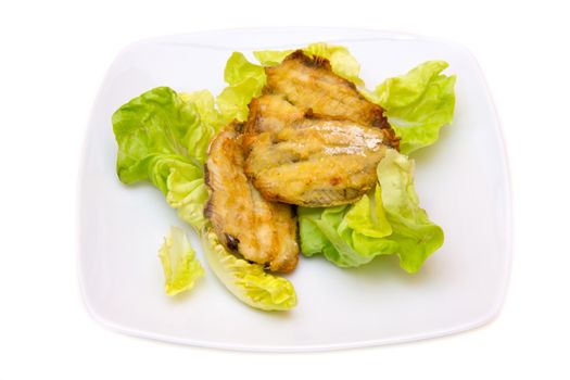 Fried fish on salad on white background