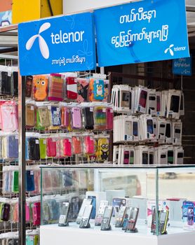 Yangon, Myanmar - October 15, 2014: Mobile phones and SIM cards have until recently been very expensive in Myanmar, but after opening the market to foreign companies like Telenor from Norway, prices have fallen dramatically.