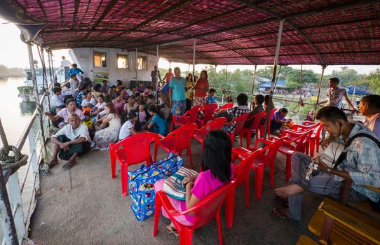Sittwe, Rakhin State, Myanmar - October 16, 2014: Passengers seated for the 6 hours voyage from Sittwe to Mrauk U on the Kaladan River in Rakhin State, Myanmar.