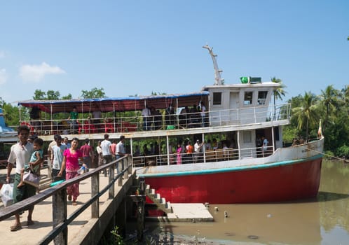 Mrauk U, Rakhin State, Myanmar - October 16, 2014: The ferry from Sittwe at the pier of the inland town Mrauk U in the Rakhin State, Myanmar short after arrival.