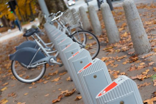 Station of urban bicycles for rent downtown. Green sustainable ecological public transport. Healthy lifestyle.