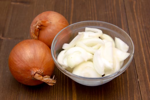 Sliced onion on bowl on wooden table