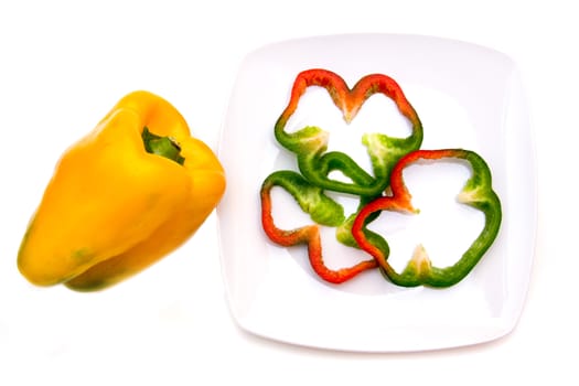 Pepper slices on plate on white background viewed from above