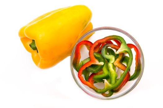 Pepper slices on bowl on white background viewed from above