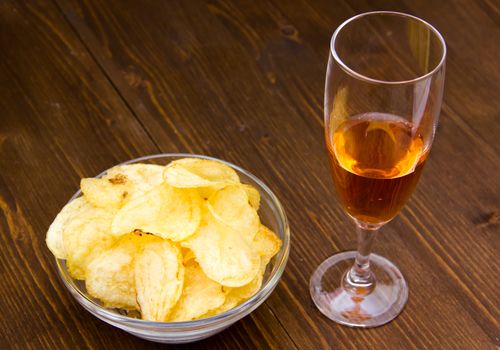 Bars with bowl of chips on wooden table