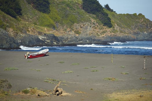 Colourful wooden fishing boats on the beach in the small coastal village of Cobquecura in Maule, Chile.