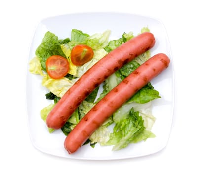 Sausages with salad on plate on white background viewed from above
