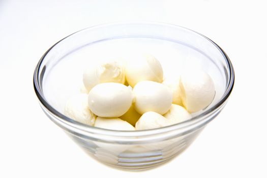 Small mozzarella in bowl on white background