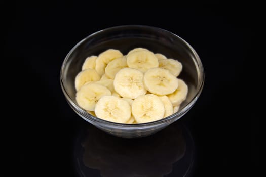 Sliced Banana on bowl reflected on black background