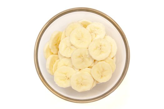 Banana slices on bowl on white background viewed from above